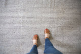 Hand woven ivory and charcoal texture of the New Turkish Kilim carpet.