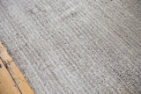 Angled detail of the hand woven Turkish Kilim's textured ivory and charcoal black fibers.