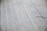 Ivory and charcoal hand woven texture on this Turkish Kilim carpet.