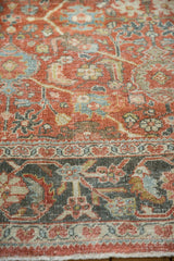 Distressed Mahal rug border showing terracotta rust, dusty teal, ivory floral, low pile wear.