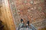 Distressed vintage Mahal rug pile showing even wear and terracotta, teal floral motifs.