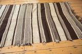 Textured ivory and chocolate brown banded stripes with fringe on a vintage Kilim runner.