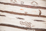Mixed-weave vintage Moroccan Kilim with natural brown stripes and small pictorial motifs.