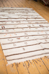 Textural mixed-weave Moroccan Kilim rug with ivory, brown stripes, pictorial details, and wispy pile.