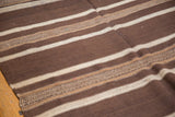 Close-up of a Moroccan Kilim carpet with natural brown and ivory geometric patterned stripe.