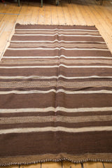 Hand-woven vintage Moroccan Kilim with natural brown and antique ivory striated patterned bands.
