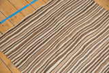 Striated handwoven texture of natural brown and beige stripes on the Moroccan Kilim.