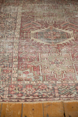 Distressed vintage Karaja rug, worn pile detail with geometric patterns in brick red, charcoal, pale green.