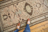Distressed vintage Serab runner with repeating geometric medallions and even low pile.