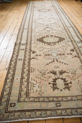 Vintage Serab runner's geometric border, low pile, and fringe in beige, brown, and pale blue.