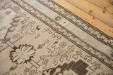 Distressed low pile with geometric coffee brown and beige patterns on vintage Serab runner.