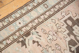 Distressed Serab runner with low pile texture, geometric border, soft beige, pale blue, and brown motifs.