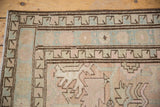 Low pile Serab runner corner: geometric coffee brown borders, faded pale blue and pink field.