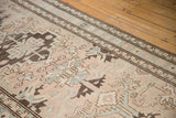Low pile texture and geometric coffee brown border motif on a distressed vintage Serab runner.
