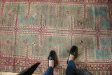 Distressed Oushak runner with geometric maze pattern in raspberry red and sky blue.