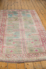 Distressed Oushak runner's unique maze pattern in softened raspberry and sky blue.