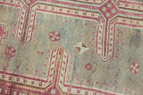 Textured pile of vintage Oushak runner with even distress in raspberry and muted blue.