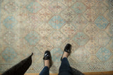 Close-up of vintage distressed Afshar rug: playful faded colors in serrated diamond pattern.