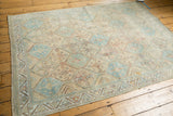 Vintage distressed Afshar rug corner, geometric border, and a visible rust stain.