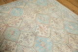 Distressed Afshar rug detail with faded ivory, sky blue, and peach serrated diamond pattern.