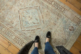 Distressed vintage Persian Shiraz rug, faded sky blue medallion and ivory geometric motifs.