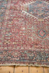 Worn fringe of a distressed vintage Karaja rug, showing brick red and teal geometric motifs.