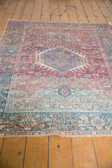 Distressed hand-knotted Karaja rug with geometric brick red and teal blue designs, fringe.