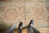 Vintage distressed Serab runner showing geometric medallions and faded beige, powder blue tones.