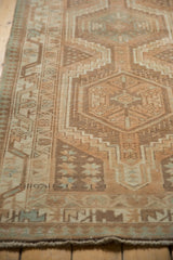 Distressed Serab runner detail: geometric patterns, muted beige, pale coffee, faint foundation.