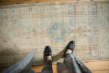 Distressed Serab runner with muted geometric patterns in ivory and seafoam green.