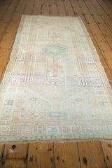 Distressed vintage Serab runner, showcasing soft beige and pale blue geometric patterns.