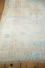 Distressed Serab runner with faded antique ivory, pale blue geometric patterns, and visible wear.