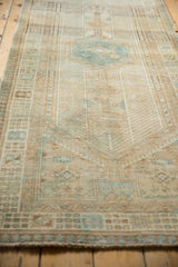 Secured fringe and geometric border patterns on a distressed vintage Serab runner.