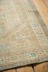 Distressed vintage Serab rug runner, showing geometric patterns, beige tones, and areas of foundation.