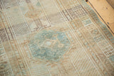 Distressed Serab rug shows pale blue medallion amidst beige field and visible foundation.