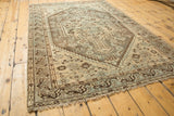 Distressed Shiraz rug with geometric border, soft fringe, and muted ivory and powder blue.