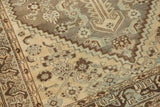 Distressed vintage Shiraz rug detail showing geometric patterns, soft wear in ivory, pewter, and powder blue.