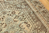 Time-softened ivory, pewter, and powder blue geometric and floral motifs on Shiraz rug.