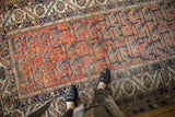 Vintage Malayer rug runner corner showing beige, navy borders, terracotta field with botehs.