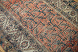 Vintage Malayer rug's peach field with interconnected vinery and worn ivory border detail.