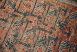 Vintage Malayer rug's terracotta field shows blue vinery, floral botehs, and pile wear.