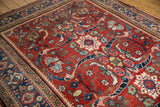 Cherry red Mahal field with scrolling cloudband vinery, multicolor floral motifs, and low pile.