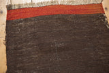 Charcoal and brick red stripes on a hand-woven vintage Turkish Kilim rug.