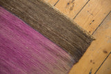 Distressed Turkish Kilim rug with textured pale purple and chocolate brown flat weave.