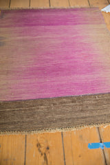 Faded pale purple and chocolate brown vintage Kilim flatweave with fringe.