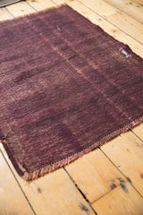 Deep wine aubergine Vintage Turkish Kilim flatweave with visible rewoven foundation and fringe.