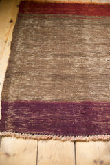 Hand-woven texture detail of coffee, aubergine, and rust horizontal bands.