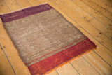 Fringed end of vintage Turkish Kilim rug with horizontal coffee brown and rust red bands.