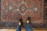 Overhead view of a Karaja rug's triple medallion and geometric field showing its vintage wear.