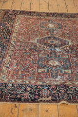 Low perspective showing the time-softened pile and geometric motifs of a vintage Karaja rug.